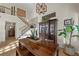 Dining table and chairs are placed next to a staircase and a dark wood china cabinet at 3324 Canyon Lake Dr, Las Vegas, NV 89117