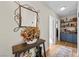 Inviting hallway featuring a decorative mirror and shelving unit at 3324 Canyon Lake Dr, Las Vegas, NV 89117