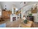 Open-concept living room with a fireplace and view to the kitchen, creating a warm and inviting atmosphere at 3324 Canyon Lake Dr, Las Vegas, NV 89117