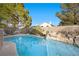 Refreshing pool featuring an attractive rock waterfall feature, set within a serene backyard at 3324 Canyon Lake Dr, Las Vegas, NV 89117