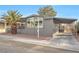 Gray single-wide manufactured home with carport and palm tree at 3580 Allegheny Dr, Las Vegas, NV 89122