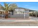 Gray single-wide manufactured home with carport and palm tree at 3580 Allegheny Dr, Las Vegas, NV 89122