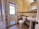 Small bathroom with pedestal sink and door at 3580 W Moberly Ave, Las Vegas, NV 89139