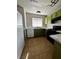 Full view of kitchen, featuring green cabinets and tile flooring at 3710 Royal Fern Cir, Las Vegas, NV 89115