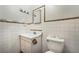 Cozy bathroom featuring tiled walls, white sink, and toilet at 3759 Glen Ave, Las Vegas, NV 89121