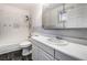 Clean bathroom, white vanity, tiled shower, and grey floor at 3759 Glen Ave, Las Vegas, NV 89121