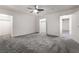 Spacious bedroom featuring neutral carpet, ceiling fan, and ample natural light at 3759 Glen Ave, Las Vegas, NV 89121