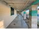 Long covered walkway with teal columns and concrete flooring at 3759 Glen Ave, Las Vegas, NV 89121