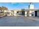 Wide view of exterior of property with turquoise trim and large concrete parking pad at 3759 Glen Ave, Las Vegas, NV 89121