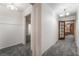 Hallway with gray carpet and white walls leading to multiple rooms at 3759 Glen Ave, Las Vegas, NV 89121