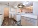 Open concept kitchen with a pass-through bar area, white cabinets, and dark wood flooring at 3759 Glen Ave, Las Vegas, NV 89121