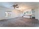 Open living room with ceiling fan, chandelier, and kitchen views at 3759 Glen Ave, Las Vegas, NV 89121