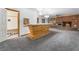 Open living room featuring a brick fireplace, wooden bar and doorway to the bathroom at 3759 Glen Ave, Las Vegas, NV 89121