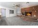 Living room with brick fireplace and grey carpet at 3759 Glen Ave, Las Vegas, NV 89121