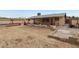 Sandy backyard with covered patio and block walls at 3766 Millwood Ave, Las Vegas, NV 89121