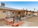 House's back with covered patio and a brick wall at 3766 Millwood Ave, Las Vegas, NV 89121