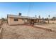 Large backyard with a walkway to the covered patio at 3766 Millwood Ave, Las Vegas, NV 89121