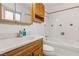 Bathroom with wood vanity, bathtub, and tiled walls at 3766 Millwood Ave, Las Vegas, NV 89121