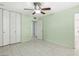 Light green bedroom with ceiling fan and built-in closet at 3766 Millwood Ave, Las Vegas, NV 89121