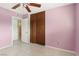 Bedroom with wood closet doors and ceiling fan at 3766 Millwood Ave, Las Vegas, NV 89121