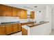 Kitchen with wood cabinets, tile floors and stainless steel sink at 3766 Millwood Ave, Las Vegas, NV 89121