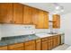 View of kitchen with wood cabinets, a double sink, and new dishwasher at 3766 Millwood Ave, Las Vegas, NV 89121