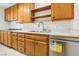 Kitchen features wood cabinets, a double sink, and energy-efficient appliances at 3766 Millwood Ave, Las Vegas, NV 89121