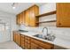 Kitchen area with wood cabinets, double sink, and exterior access at 3766 Millwood Ave, Las Vegas, NV 89121