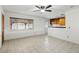 Open concept kitchen and living area with wood cabinets and tile floors at 3766 Millwood Ave, Las Vegas, NV 89121