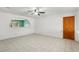 Spacious living room featuring tile floors and a ceiling fan at 3766 Millwood Ave, Las Vegas, NV 89121