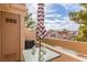 Cozy balcony features seating, an umbrella, and views of the community pool and surrounding buildings at 3800 Desert Marina Dr # 158, Laughlin, NV 89029