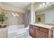 Bathroom with soaking tub, shower, granite vanity, and tile flooring at 4050 Pacific Harbors Dr # 201, Las Vegas, NV 89121