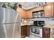 Stainless steel appliances and wood cabinets highlight this kitchen at 4050 Pacific Harbors Dr # 201, Las Vegas, NV 89121