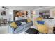 Living room with gray sofa, yellow armchair, and open kitchen area at 4050 Pacific Harbors Dr # 201, Las Vegas, NV 89121