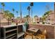 Private patio with table and chairs, offering views of the community at 4050 Pacific Harbors Dr # 201, Las Vegas, NV 89121