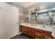 Double vanity bathroom with wood cabinets and a shower at 424 Sarajane Lane, Las Vegas, NV 89107