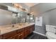 Bathroom boasts double sinks, wood cabinets, and a shower at 424 Sarajane Lane, Las Vegas, NV 89107