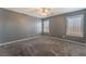 Spacious bedroom with ceiling fan, grey walls, and carpet flooring at 424 Sarajane Lane, Las Vegas, NV 89107