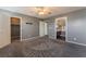 Bright bedroom with ceiling fan, grey walls, carpet, and walk-in closet at 424 Sarajane Lane, Las Vegas, NV 89107