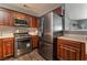 Modern kitchen features stainless steel appliances and dark wood cabinetry at 424 Sarajane Lane, Las Vegas, NV 89107