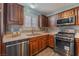 Modern kitchen with stainless steel appliances and wood cabinetry at 424 Sarajane Lane, Las Vegas, NV 89107