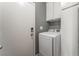 Functional laundry room, including a washer, dryer, and storage at 424 Sarajane Lane, Las Vegas, NV 89107