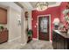 Elegant entryway with a dark wood door and red accent wall at 4356 La Romita St # 2, Pahrump, NV 89061