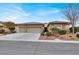 Single-story home with three-car garage, landscaping, and stone accents at 4356 La Romita St # 2, Pahrump, NV 89061