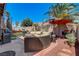 Backyard patio with seating area, fire pit, and built-in BBQ at 448 Bright Moon Ave, North Las Vegas, NV 89084