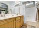 Bright bathroom with double sinks, shower/tub combo, and wood cabinets at 448 Bright Moon Ave, North Las Vegas, NV 89084