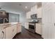 Modern white kitchen with stainless steel appliances and granite countertops at 4625 Ridgeley Ave # 103, North Las Vegas, NV 89084