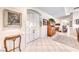 Elegant foyer featuring tiled floors, a decorative table, and double doors at 471 Eagle Vista Dr, Henderson, NV 89012