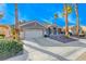 Beautiful single-story home with a well-manicured lawn, palm trees, and a spacious two-car garage at 471 Eagle Vista Dr, Henderson, NV 89012