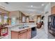 Modern kitchen with stainless steel appliances and breakfast bar, seamlessly connecting to a living space at 471 Eagle Vista Dr, Henderson, NV 89012